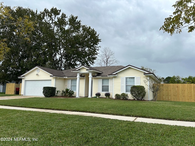 ranch-style house featuring a front lawn and a garage