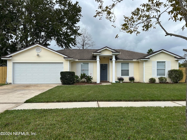 single story home with a front lawn and a garage