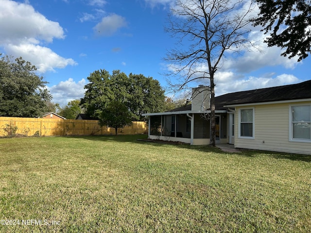 view of yard featuring a sunroom