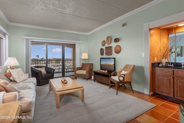 living room with sink, ornamental molding, and light tile patterned floors