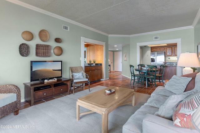 living room with crown molding and dark tile patterned flooring