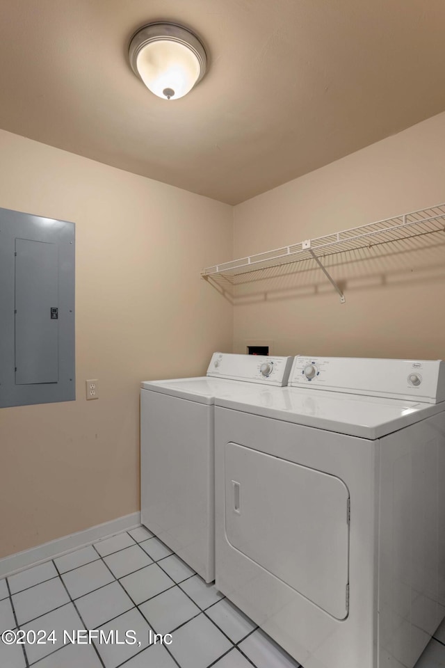 washroom featuring light tile patterned flooring, electric panel, and washer and clothes dryer