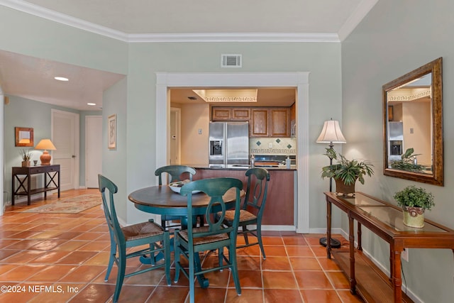 tiled dining room with crown molding