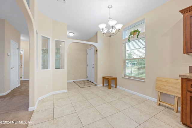 tiled dining space featuring an inviting chandelier