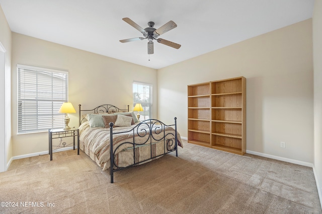 bedroom with light colored carpet and ceiling fan