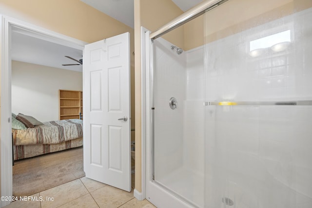 bathroom featuring tile patterned flooring, an enclosed shower, and ceiling fan