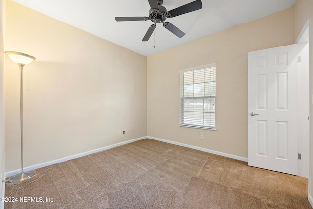 spare room with carpet floors and ceiling fan