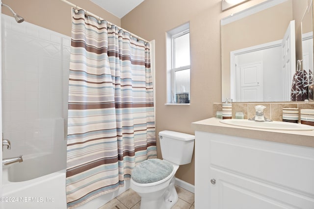 full bathroom featuring shower / bath combo with shower curtain, vanity, tile patterned flooring, and toilet