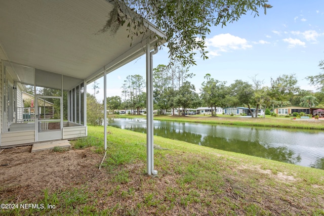 view of yard with a water view and a sunroom