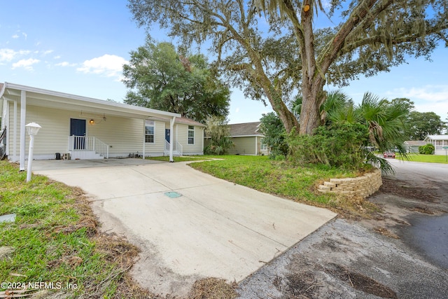 rear view of property featuring a lawn