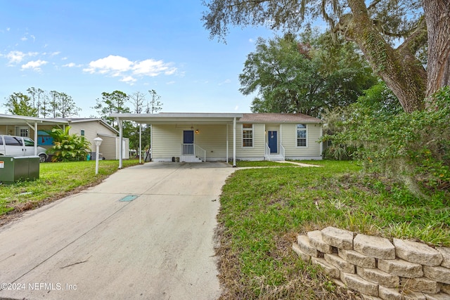 ranch-style home with a front lawn and a carport