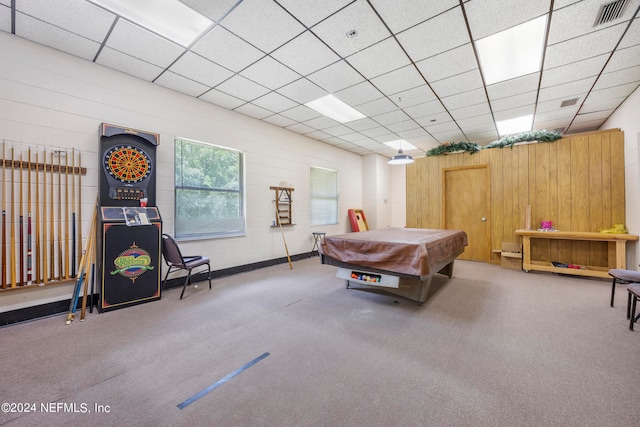 recreation room featuring pool table, wood walls, a drop ceiling, and carpet floors