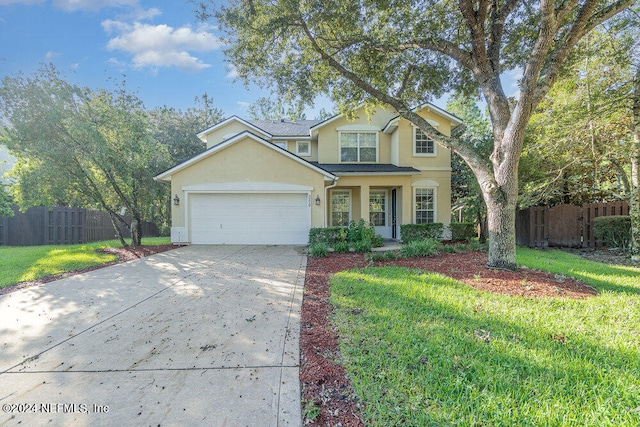 view of property with a front lawn and a garage