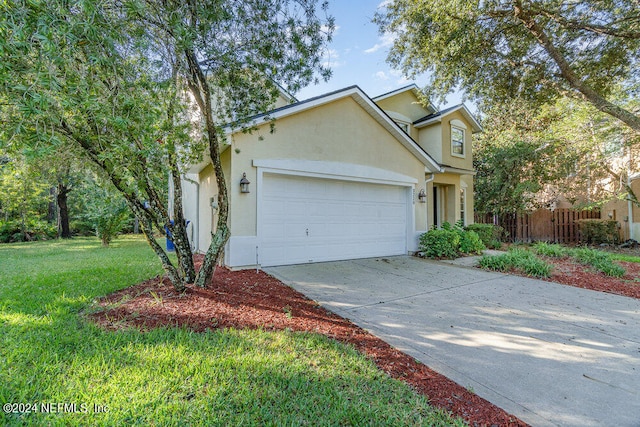 view of front of property featuring a front lawn and a garage