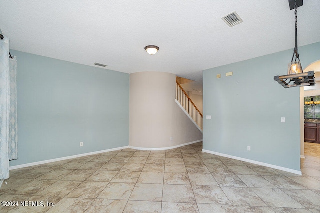 spare room featuring a textured ceiling