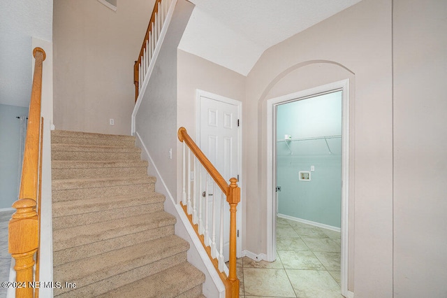 staircase with vaulted ceiling