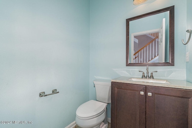 bathroom with toilet and vanity