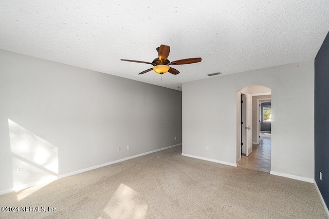 carpeted empty room with a textured ceiling and ceiling fan