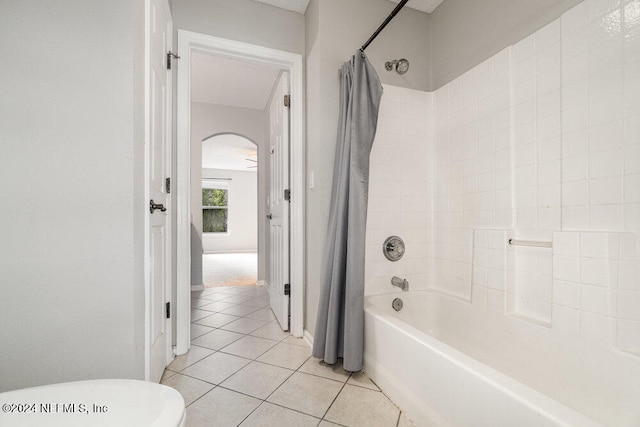 bathroom with tile patterned flooring and shower / bath combination with curtain