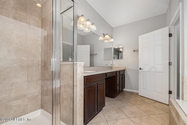 bathroom featuring walk in shower, vanity, and tile patterned floors