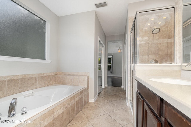 bathroom with vanity, tile patterned floors, and plus walk in shower