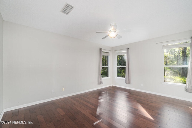 unfurnished room featuring ceiling fan and dark hardwood / wood-style flooring