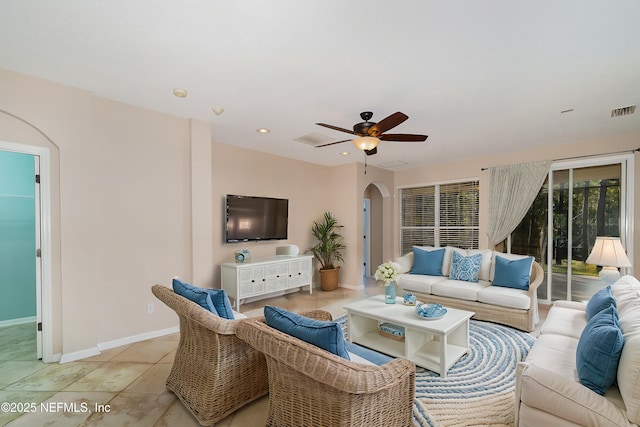 tiled living room with ceiling fan