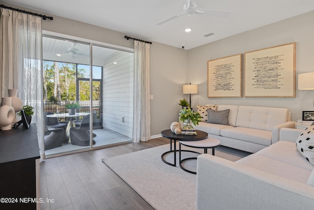 living room with wood-type flooring and ceiling fan