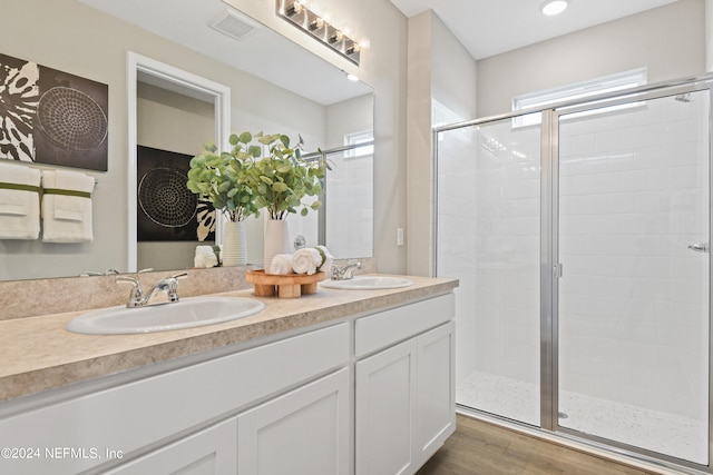 bathroom featuring an enclosed shower, hardwood / wood-style flooring, and vanity