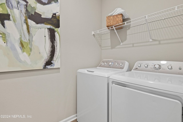 clothes washing area with washer and dryer