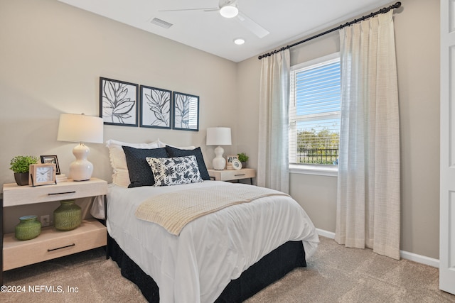 bedroom featuring light colored carpet and ceiling fan