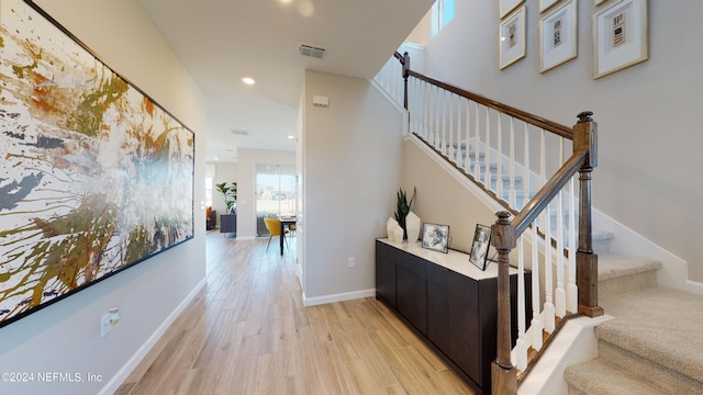 stairs featuring hardwood / wood-style flooring