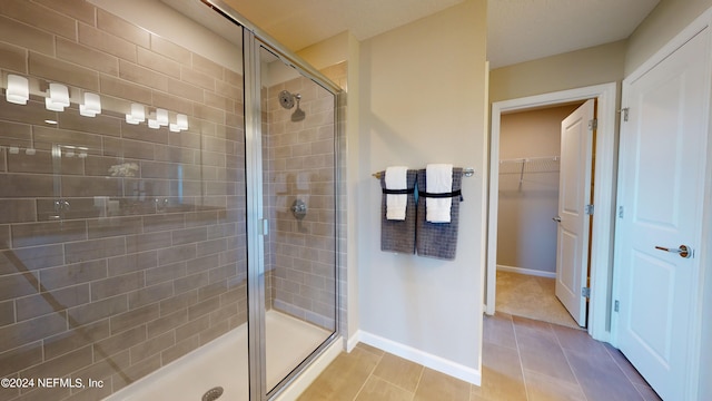 bathroom featuring walk in shower and tile patterned floors