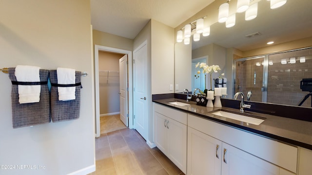 bathroom with vanity, tile patterned flooring, and an enclosed shower