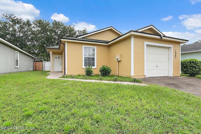 ranch-style home featuring a front yard and a garage