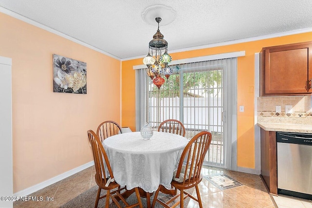 dining area featuring ornamental molding, light tile patterned floors, a chandelier, and a textured ceiling