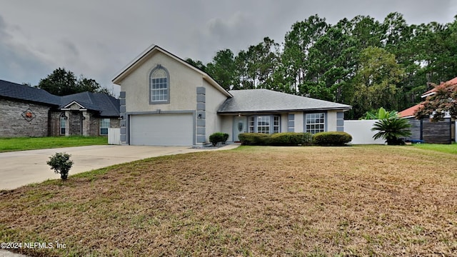 view of property featuring a front lawn