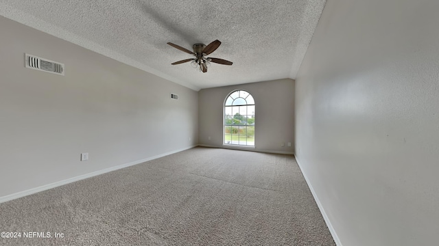 spare room with a ceiling fan, visible vents, carpet floors, and baseboards