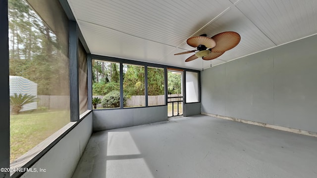 unfurnished sunroom with ceiling fan