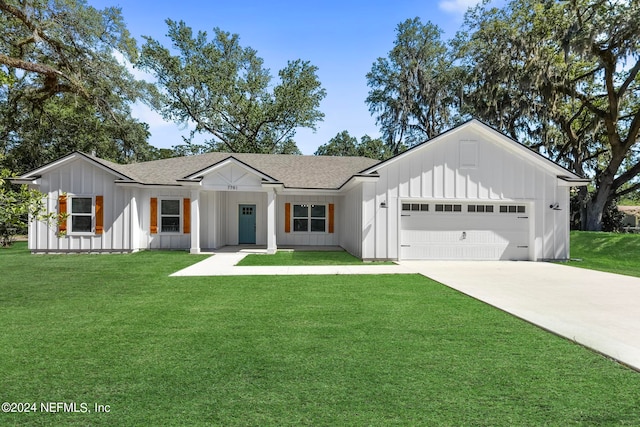 modern farmhouse style home with a front yard and a garage