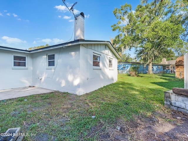 back of house with a yard