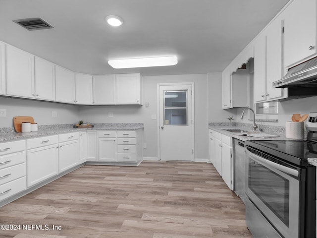 kitchen with sink, extractor fan, white cabinetry, light wood-type flooring, and appliances with stainless steel finishes