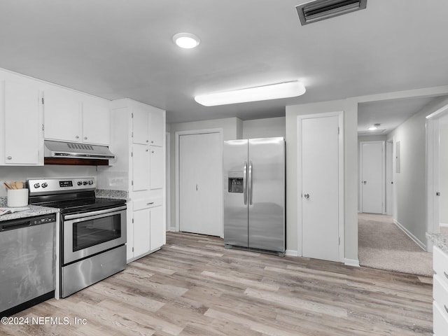 kitchen with white cabinets, appliances with stainless steel finishes, and light hardwood / wood-style flooring