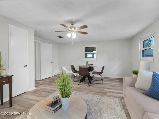 living room featuring light wood-type flooring and ceiling fan