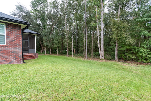 view of yard with a sunroom