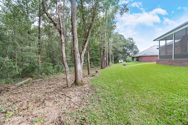 view of yard featuring a sunroom