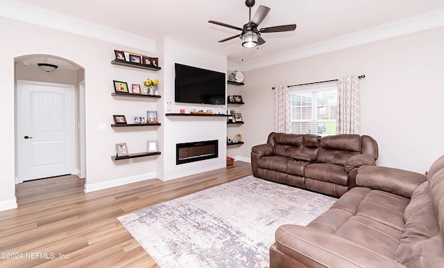 living room with ceiling fan, hardwood / wood-style flooring, and ornamental molding