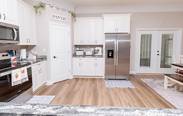 kitchen featuring light hardwood / wood-style floors, french doors, white cabinetry, and stainless steel appliances