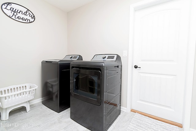 clothes washing area featuring washing machine and clothes dryer