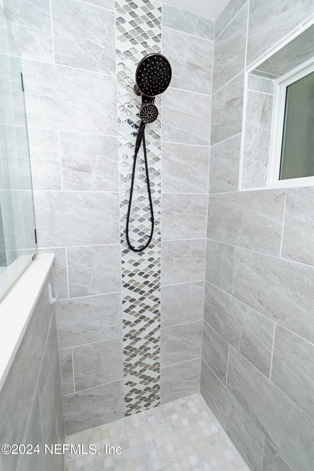 bathroom with tiled shower